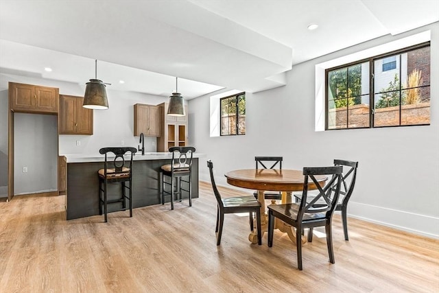 dining space featuring sink and light hardwood / wood-style floors