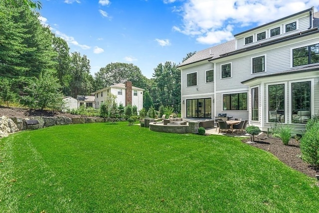 back of property featuring a yard and a patio