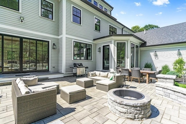 view of patio / terrace featuring a grill and an outdoor living space with a fire pit