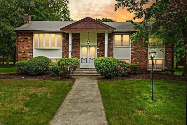 18 Sunset Dr, Sharon, MA 02067 - view of front of house featuring a yard, brick siding, and a chimney