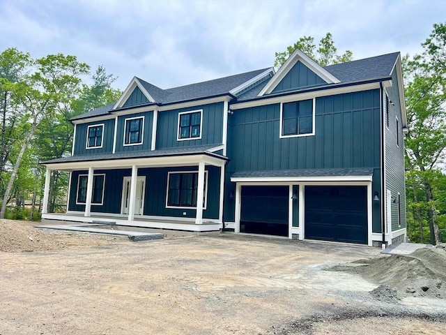 784 Main St, Hudson, MA 01749 - view of front facade with a shingled roof, a garage, covered porch, board and batten siding, and driveway