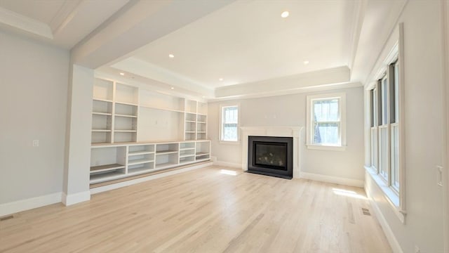 784 Main St, Hudson, MA 01749 - unfurnished living room with a raised ceiling, light wood-style floors, ornamental molding, a fireplace with flush hearth, and recessed lighting