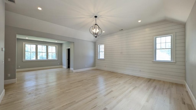 784 Main St, Hudson, MA 01749 - spare room with lofted ceiling, light wood-style flooring, a chandelier, recessed lighting, and wooden walls