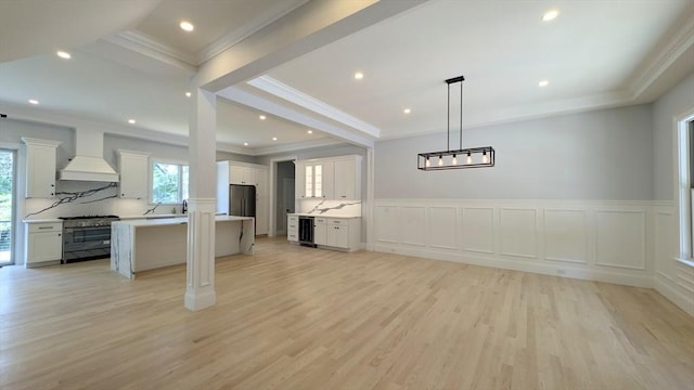 784 Main St, Hudson, MA 01749 - kitchen with stainless steel appliances, custom exhaust hood, open floor plan, beverage cooler, and ornamental molding