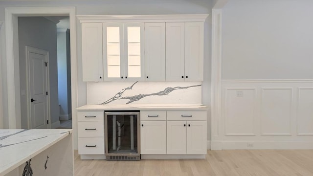 784 Main St, Hudson, MA 01749 - bar featuring beverage cooler, light wood-style flooring, and tasteful backsplash