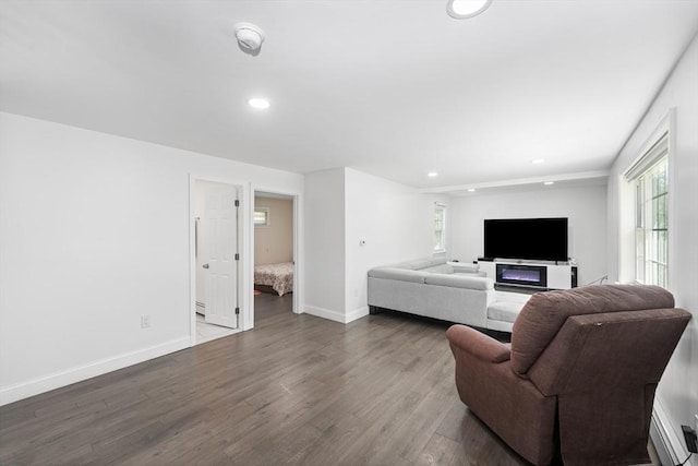 5 Woodland Dr, Oxford, MA 01540 - living area with recessed lighting, dark wood finished floors, plenty of natural light, and a baseboard heating unit