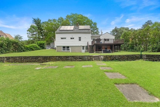 5 Woodland Dr, Oxford, MA 01540 - rear view of property with stairway, a wooden deck, roof mounted solar panels, and a lawn