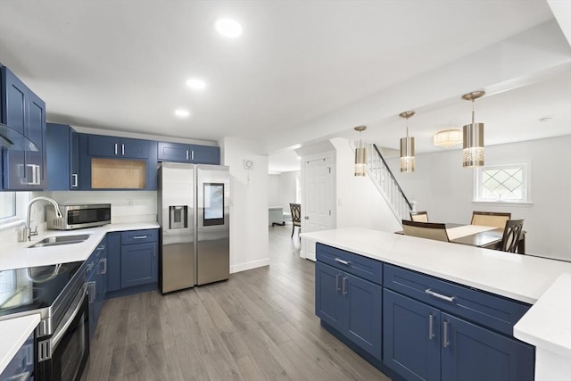 5 Woodland Dr, Oxford, MA 01540 - kitchen with appliances with stainless steel finishes, blue cabinets, light countertops, wood finished floors, and recessed lighting