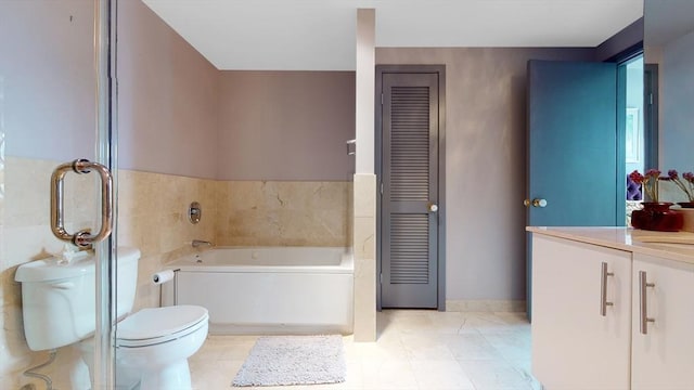 full bath featuring toilet, a bath, vanity, and tile patterned flooring