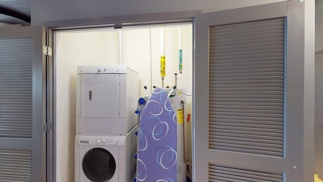 washroom featuring laundry area and stacked washer and dryer