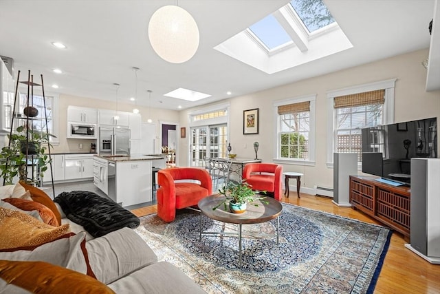 living room featuring a baseboard heating unit and light wood-type flooring