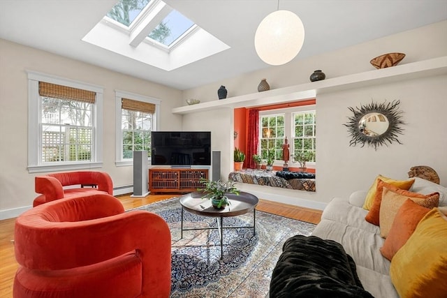 living room with a baseboard heating unit, hardwood / wood-style floors, and french doors