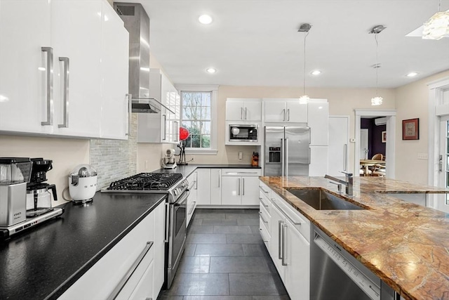 kitchen featuring white cabinetry, sink, decorative light fixtures, and stainless steel appliances