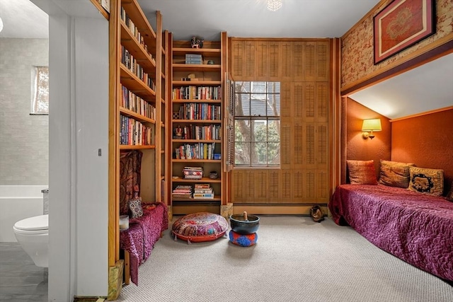 carpeted bedroom with baseboard heating and ensuite bath