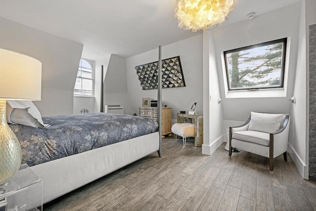 bedroom featuring hardwood / wood-style floors and a notable chandelier