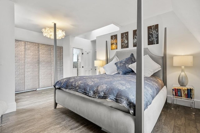 bedroom featuring hardwood / wood-style floors and a notable chandelier