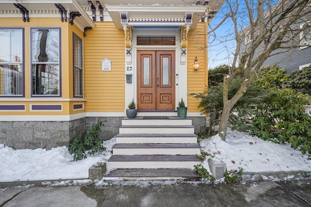 view of snow covered property entrance