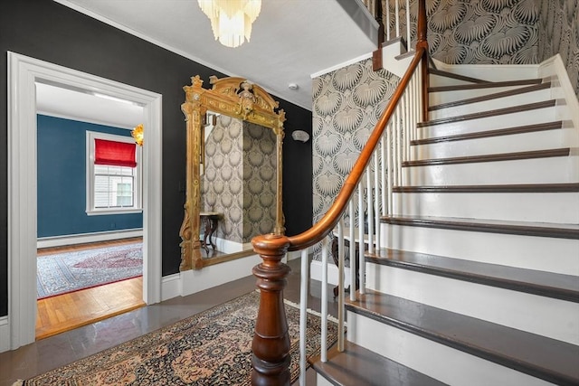 stairs featuring baseboard heating and ornamental molding