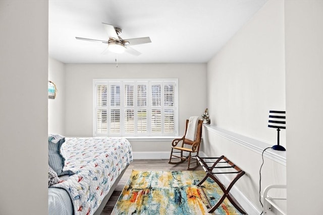 bedroom with baseboards, ceiling fan, and wood finished floors