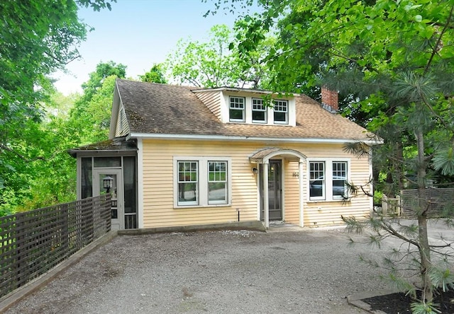100 Main, Acton, MA 01720 - bungalow-style house with a chimney, a sunroom, a shingled roof, and gravel driveway