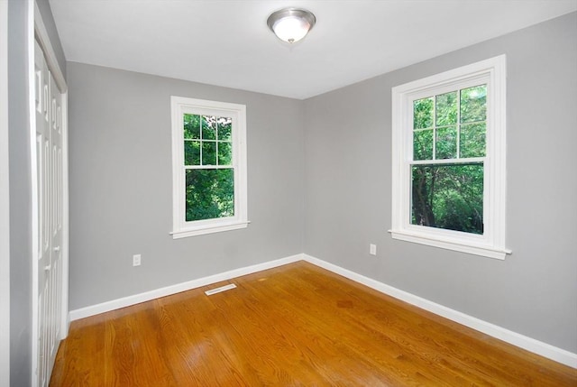 100 Main, Acton, MA 01720 - unfurnished bedroom featuring wood finished floors, baseboards, and a closet
