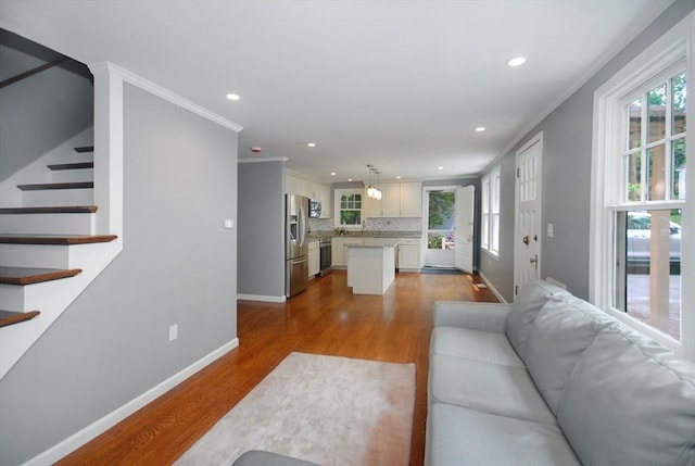 100 Main, Acton, MA 01720 - living room featuring stairway, dark wood-style flooring, healthy amount of natural light, baseboards, and recessed lighting