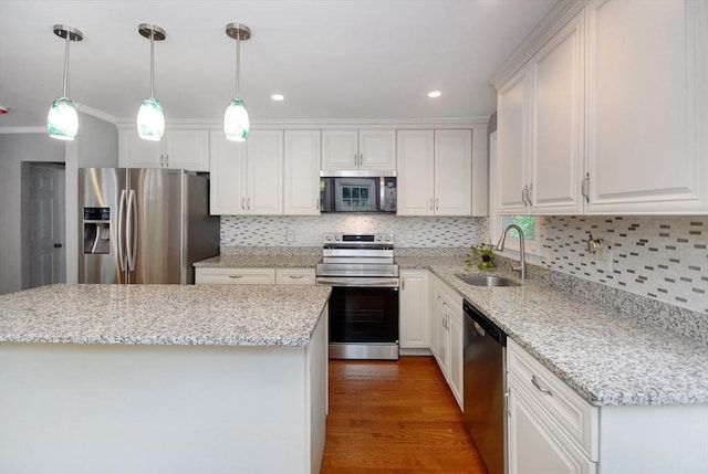 100 Main, Acton, MA 01720 - kitchen featuring appliances with stainless steel finishes, a sink, white cabinetry, tasteful backsplash, and recessed lighting