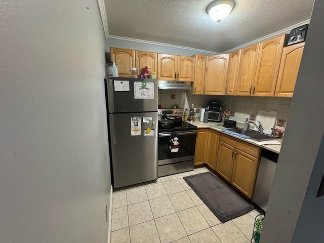 kitchen featuring decorative backsplash, appliances with stainless steel finishes, under cabinet range hood, a sink, and light tile patterned flooring