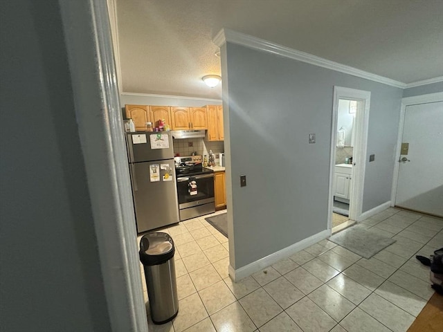 kitchen with light tile patterned flooring, under cabinet range hood, appliances with stainless steel finishes, and ornamental molding