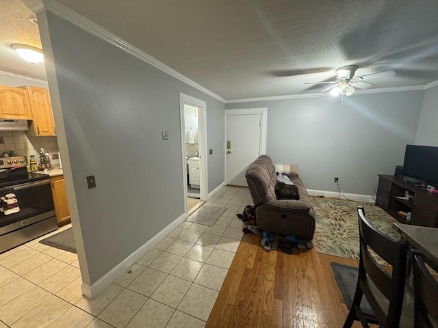 living room with light tile patterned flooring, crown molding, and baseboards