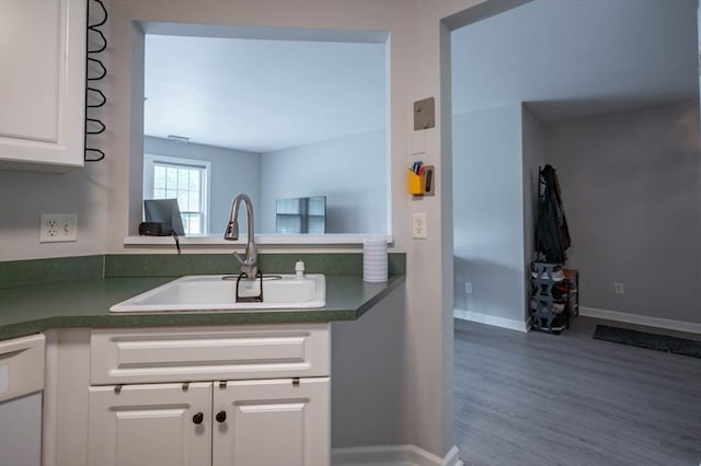1 Riverview Blvd Unit 2-213, Methuen, MA 01844 - kitchen with dark countertops, a sink, white cabinetry, white dishwasher, and wood finished floors