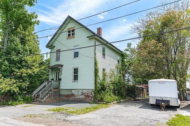 view of home's exterior with a chimney