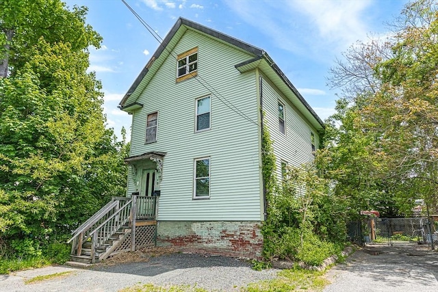 view of side of home featuring fence