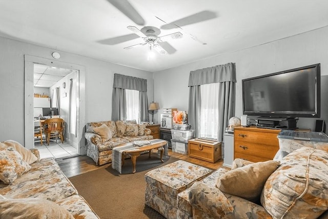 living area with plenty of natural light, light wood-style flooring, and a ceiling fan