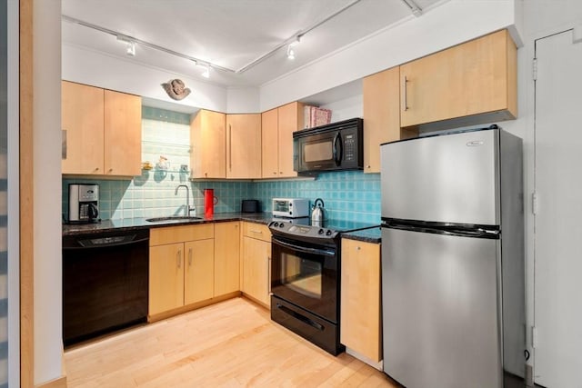 29 Concord Ave Unit 302, Cambridge, MA 02138 - kitchen with black appliances, light brown cabinetry, a sink, light wood-style floors, and backsplash