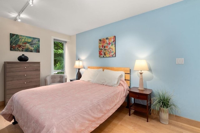 29 Concord Ave Unit 302, Cambridge, MA 02138 - bedroom with wood finished floors, rail lighting, and baseboards