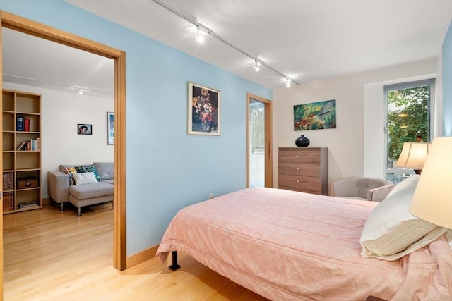29 Concord Ave Unit 302, Cambridge, MA 02138 - bedroom featuring track lighting, light wood finished floors, access to exterior, and baseboards