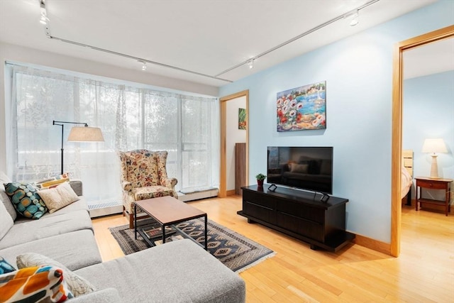 29 Concord Ave Unit 302, Cambridge, MA 02138 - living room with rail lighting, a baseboard radiator, and wood finished floors