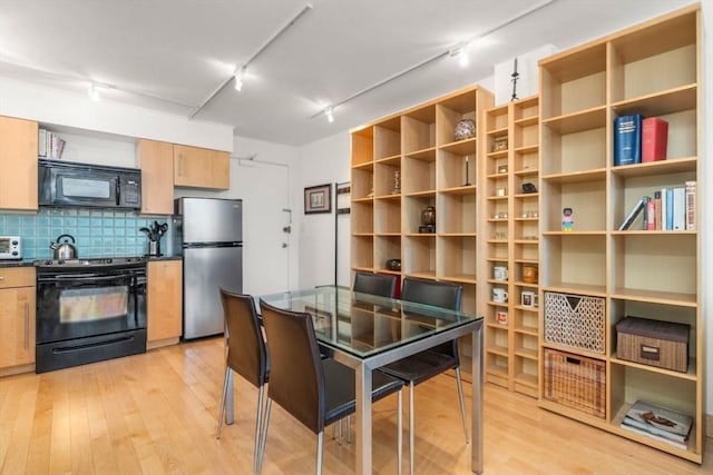 29 Concord Ave Unit 302, Cambridge, MA 02138 - kitchen featuring black appliances, track lighting, dark countertops, and light wood-style flooring