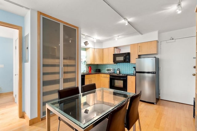 29 Concord Ave Unit 302, Cambridge, MA 02138 - kitchen featuring black appliances, track lighting, light brown cabinetry, light wood finished floors, and dark countertops