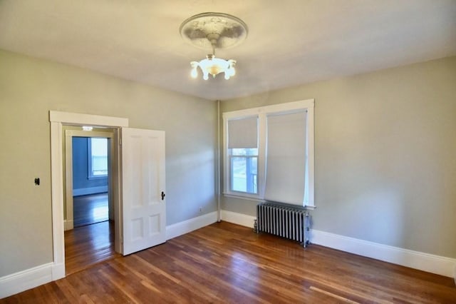 15-1/2 Tremlett St, Boston, MA 02124 - spare room featuring radiator, a chandelier, wood finished floors, and baseboards