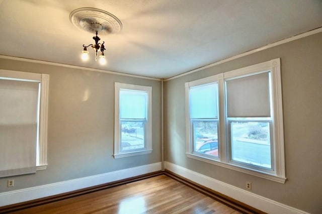 15-1/2 Tremlett St, Boston, MA 02124 - unfurnished room featuring crown molding, wood finished floors, baseboards, and a chandelier