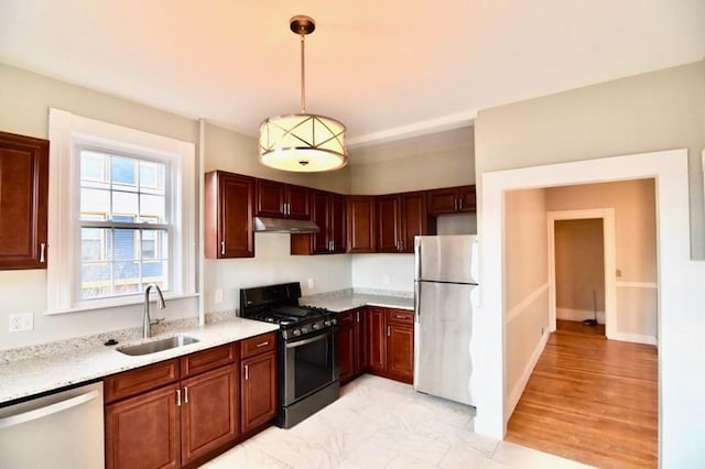 15-1/2 Tremlett St, Boston, MA 02124 - kitchen featuring appliances with stainless steel finishes, under cabinet range hood, a sink, and pendant lighting