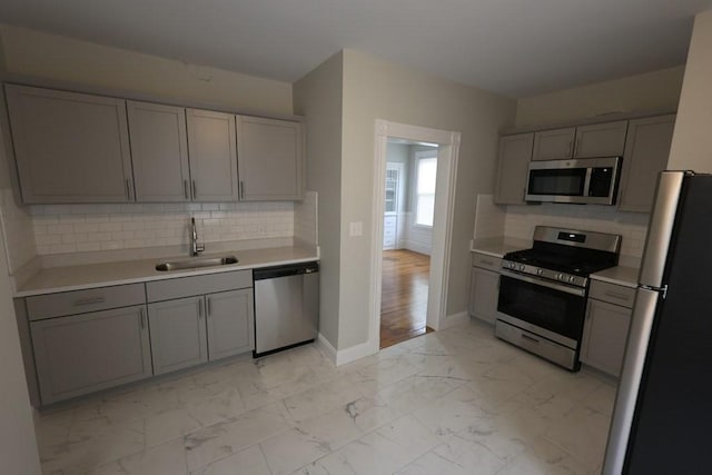 15-1/2 Tremlett St, Boston, MA 02124 - kitchen with stainless steel appliances, a sink, light marble finish flooring, gray cabinets, and light countertops