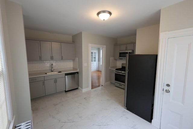 15-1/2 Tremlett St, Boston, MA 02124 - kitchen with stainless steel appliances, gray cabinetry, a sink, and light marble finish flooring