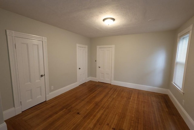 15-1/2 Tremlett St, Boston, MA 02124 - empty room featuring baseboards, dark wood-style floors, and a textured ceiling