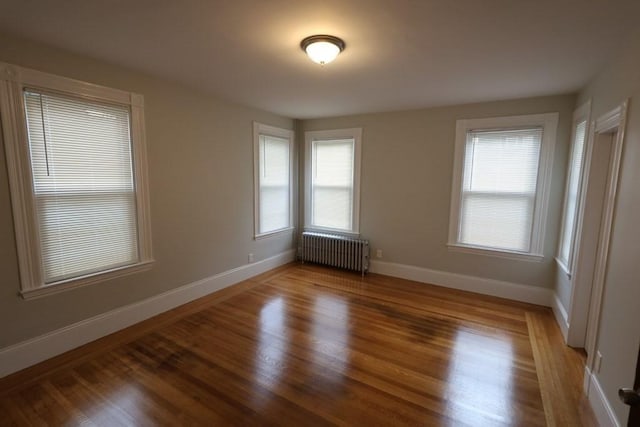 15-1/2 Tremlett St, Boston, MA 02124 - empty room with radiator, baseboards, and light wood-style flooring