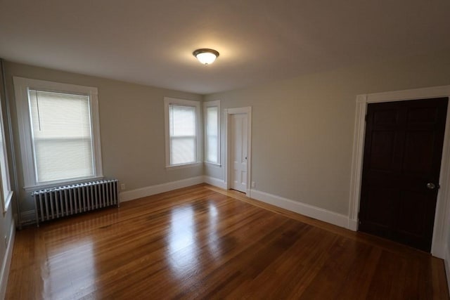 15-1/2 Tremlett St, Boston, MA 02124 - spare room with radiator heating unit, baseboards, and wood finished floors
