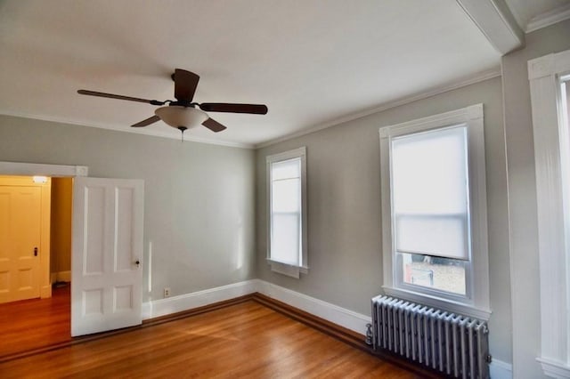 15-1/2 Tremlett St, Boston, MA 02124 - spare room featuring radiator heating unit, wood finished floors, crown molding, baseboards, and ceiling fan