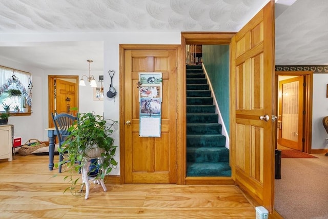 67 Main St, Atkinson, NH 03811 - stairs featuring wood finished floors and a chandelier